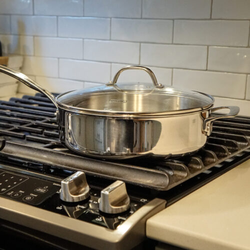 Stainless Sauté Pan with Glass Lid on a stove